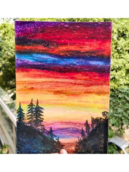 A dramatic sunset landscape created with oil pastels. This medium is perfect for blending rich, intense colors to capture the beauty of nature.