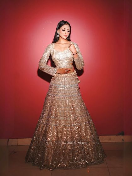 Another stunning full-length shot of the golden sequin lehenga.