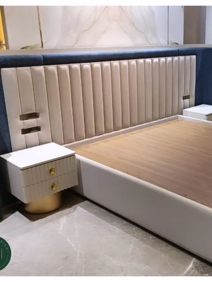 We crafted this statement bed with a dramatic, winged headboard featuring both channel tufting and a two-tone color scheme of blue and cream. The integrated nightstands with gold-plated bases complete this luxurious, modern look.