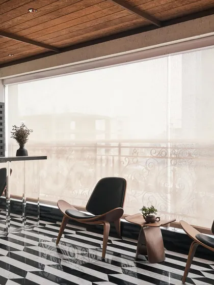 For this balcony, I designed a space that could be enclosed with a retractable screen, making it usable year-round. The custom black and white marble flooring is reflected in the mirrored bar counter, making the area feel expansive and luxurious.