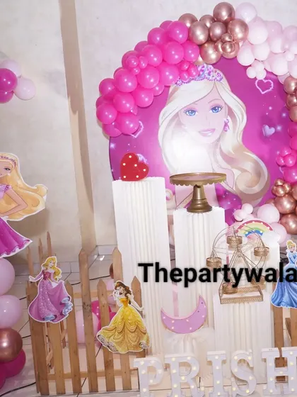 A classic Barbie theme is always a hit! This setup features a big backdrop with Barbie's face, a pink and rose gold balloon arch, and life-size cutouts of Barbie and other princesses. It's perfect for making your little girl feel like a star.