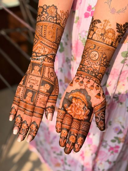 A full view of the baby shower mehendi, showing the detailed work on both hands, including a Ganesha for blessings.
