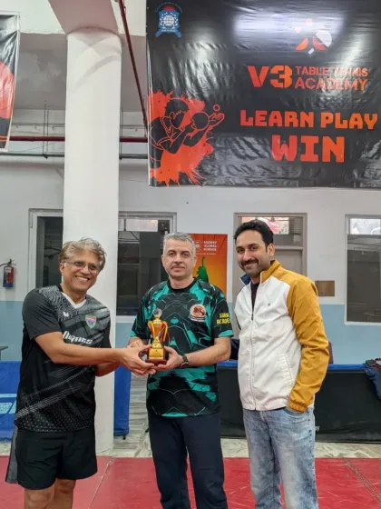 Awarding a trophy to a doubles player at our corporate championship. I organize these events to foster sportsmanship and competition within the corporate community.