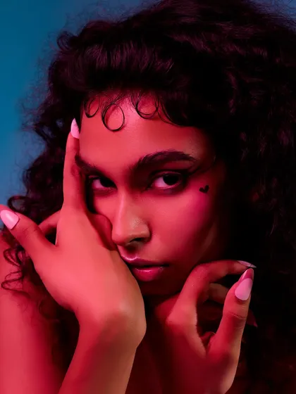 A moody beauty shot using colored gels. The red light adds drama and intensity, highlighting the model's features in a non-traditional way.