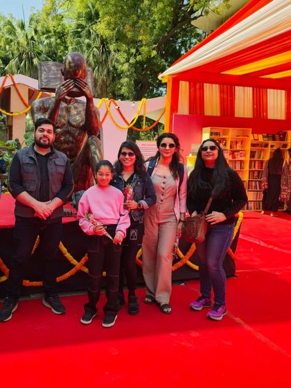 Students and instructors gather for a photo at a Women's Day art event at Lalit Kala Akademi.