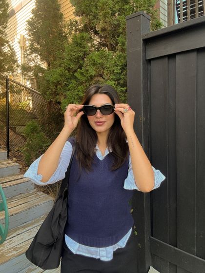 A candid moment adjusting my sunglasses, adding a natural feel to the series.