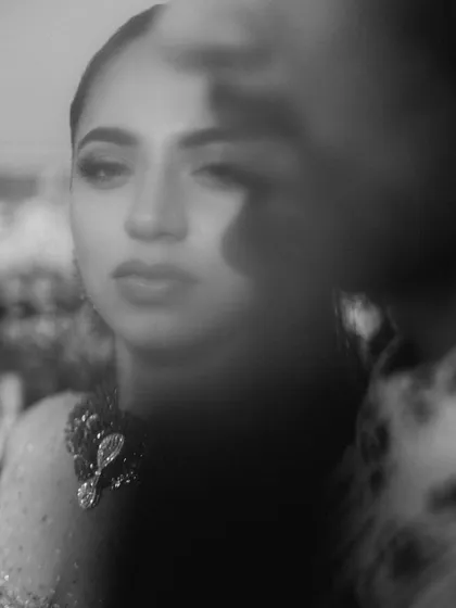 A blurry, artistic black and white close-up of the bride. This abstract portrait focuses on emotion and mood rather than sharp details, creating a soulful and mysterious image.