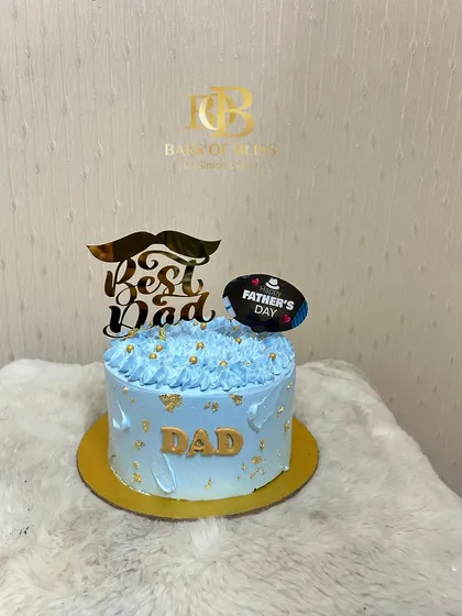 A light blue "Best Dad" cake with a mustache topper, perfect for showing your appreciation on Father's Day.