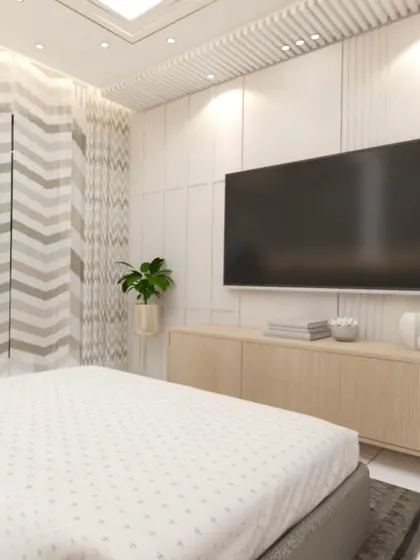 The view from the bed in this modern bedroom, showing the TV unit and chevron-patterned curtains. The design focuses on clean lines and a light, airy feel.