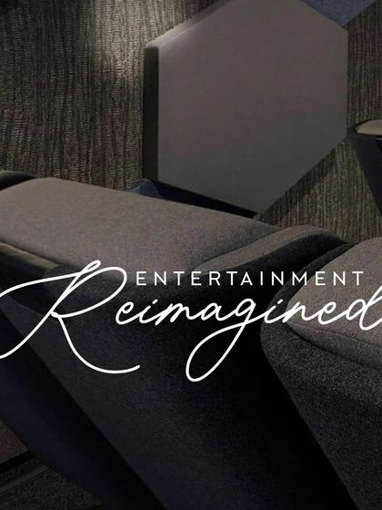 A closer look at the design elements of our "Entertainment Reimagined" concept. Notice the textured wall panels for acoustic treatment, the precise placement of recessed ceiling lights, and the comfortable, fabric-upholstered cinema seats.