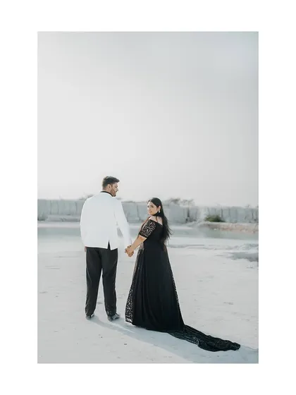 A stylish shot of the couple walking hand-in-hand at a mineral quarry, with the bride looking back at the camera.