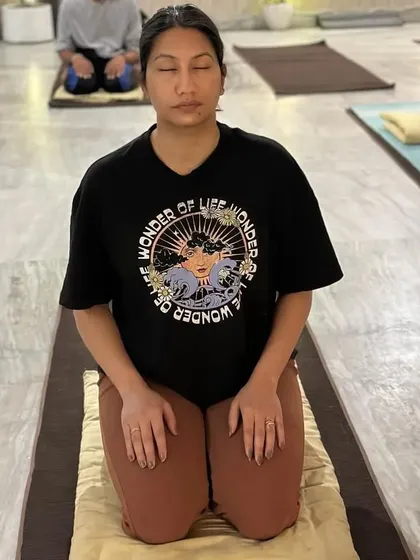 A practitioner holds a posture during an Angamardana session. The focus is on the process and inner alignment, not just achieving the perfect physical form. This is how the body becomes a vessel for a higher possibility.