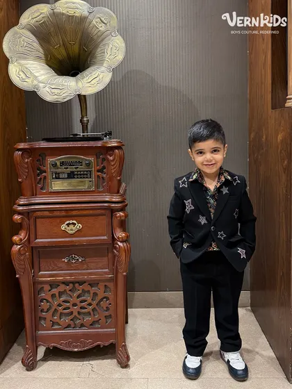 Starry vibes and a killer fit. This little gentleman looks sharp in our custom black blazer, hand-embellished with star details for a touch of glam.