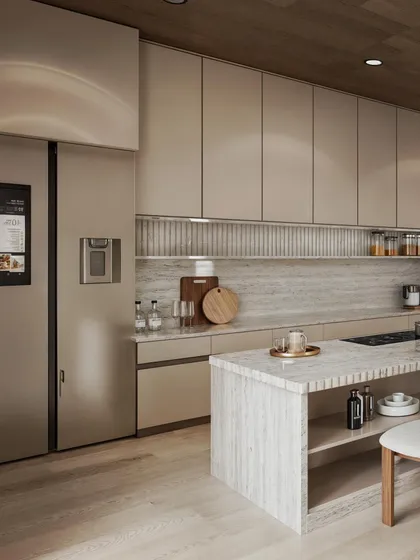 A close-up of the kitchen from the same project, highlighting the sleek, handle-less cabinetry and the marble island.