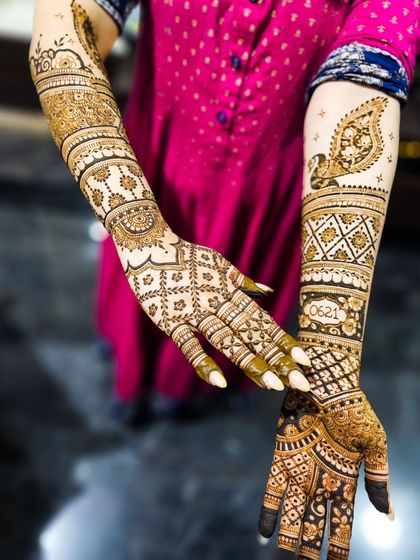 A view showing both the front and back of the hands, with a personalized date and peacock design.