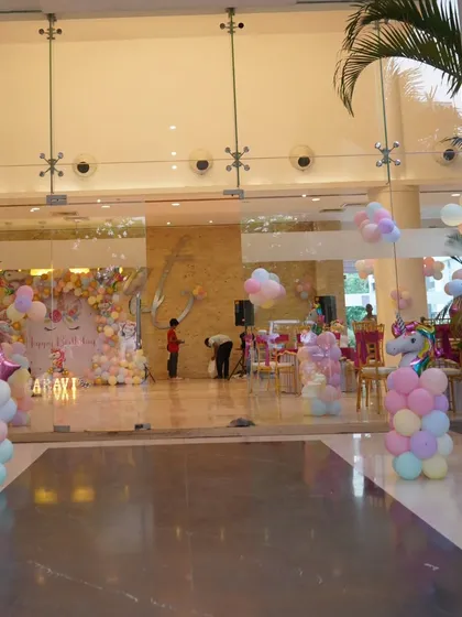 A wide view of the Unicorn party venue, showing the entrance decor and the main stage, creating an immersive experience for guests from the moment they arrive.
