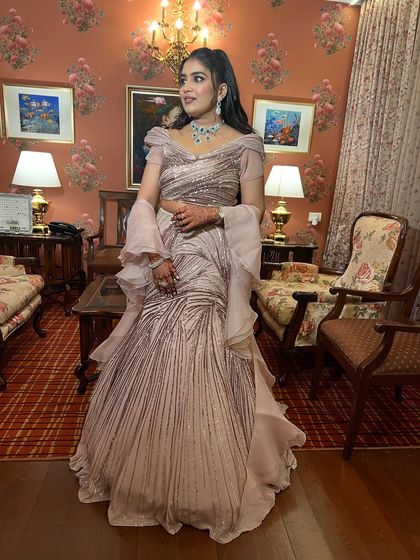 An ethereal engagement glam look. The client looks stunning in a Gaurav Gupta outfit with a luminous base and softly defined eyes.