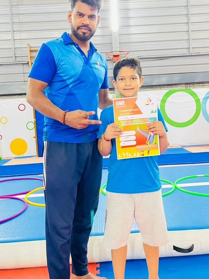 This student is excited to show off the "JUMP" certificate he earned.