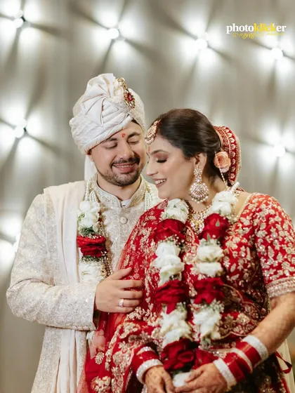 A candid, happy moment between the bride and groom right after their Jaimala ceremony, their smiles reflecting the joy of being newly married.