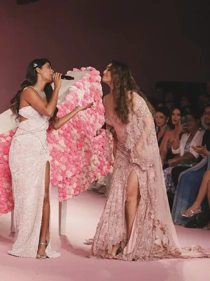 A beautiful interaction on the runway, with the floral-covered piano serving as a centerpiece. My designs often incorporate functional elements that become stages for memorable moments.