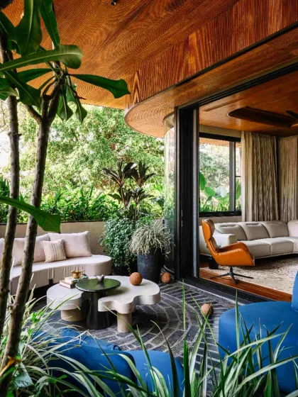We believe in blurring the boundary between the interior and the exterior. In this Bengaluru residence, the living space flows seamlessly onto a lush terrace, borrowing the surrounding trees into the home's narrative and fostering a deep connection with nature.
