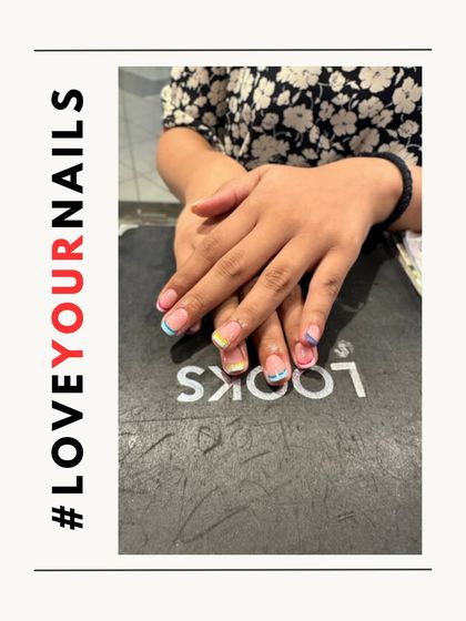 Another view of the pastel rainbow French tips. This style is a great way to incorporate color into your look while keeping the design clean and simple.