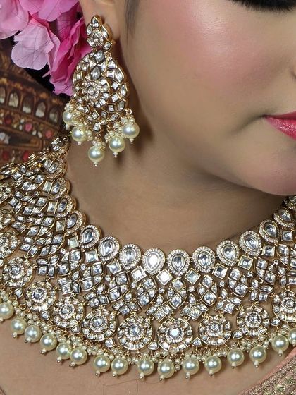 A detailed shot of a heavy Polki and pearl bridal necklace. The mix of different shaped stones and pearl accents creates a rich and textured look.