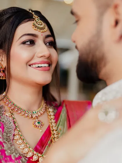 An intimate close-up of the couple. This shot highlights the bride's radiant makeup and genuine happiness.