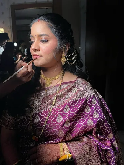 A candid shot of me applying lipstick on a bride. Every detail matters for the perfect finish.