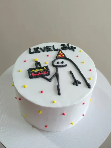 A fun and quirky bento cake with a hand-piped meme design, perfect for a small, personal celebration.