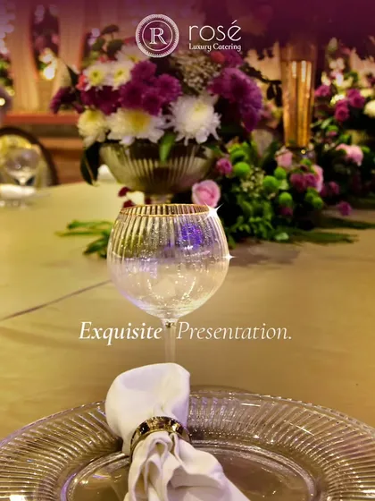 Exquisite presentation is key to the luxury experience. This close-up of an elegant place setting, with a crisp napkin and fine glassware, highlights our attention to every detail of your event's decor.