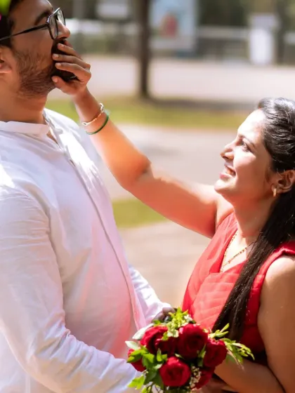 The best moments are often the unscripted ones. This playful, candid photo from a pre-wedding session captures a sweet, spontaneous interaction that truly shows the couple's personality.