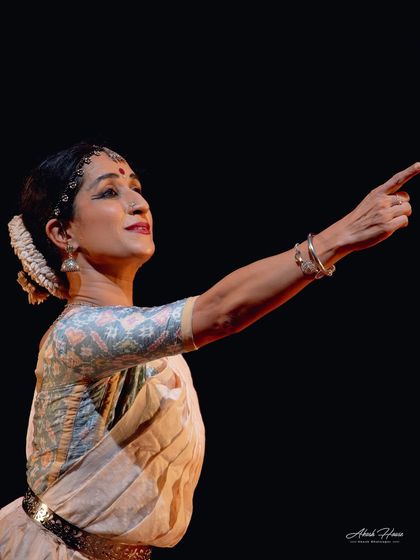 A simple gesture, pointing towards the distance, can convey so much. Is she pointing to a lover, a god, or a distant memory? The story is in the eyes.