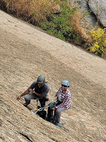 Two climbers working together at a belay station on Talai Betta. Multi pitch climbing is all about partnership and trust.
