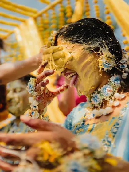The pure, uninhibited joy of a Haldi ceremony. We live for these candid moments, getting right into the action to capture the real laughter and playful chaos. This shot is all about raw energy and celebration.