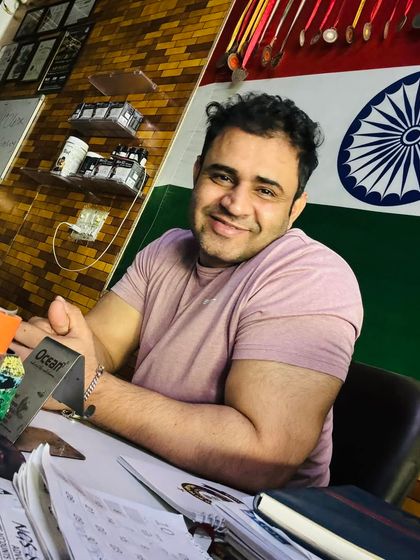 At my desk, planning workouts and diets for my clients. Every plan is tailored and gets my full attention.