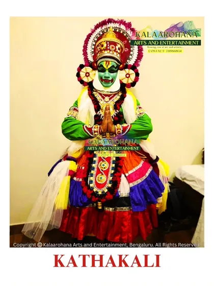 A full view of a Kathakali artist in traditional attire. Every detail, from the vibrant green 'Pacha' makeup signifying a heroic character to the elaborate costume, is meticulously prepared to preserve the authenticity of this classical dance-drama from Kerala.