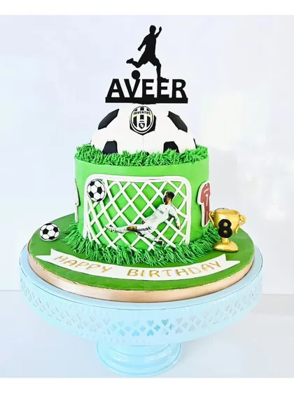 Score a goal with the birthday boy! This football-themed cake features a green field, a goalie in action, and a personalized topper. It's a fantastic choice for any young soccer fan's celebration.