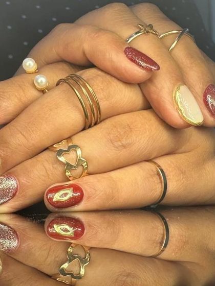 A full view of the sophisticated red, nude, and glitter nail art set.