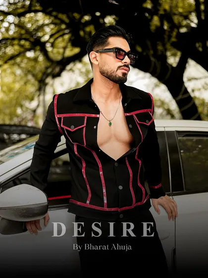 Another view of the black and red piped jacket, worn open to reveal a confident physique. The red lines add a touch of daring color.