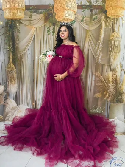 Welcome to our cozy studio. Here, we can create any look you dream of, like this elegant boho-chic setup with a stunning off-shoulder magenta gown and a delicate tiara for that perfect queen-mother feeling.