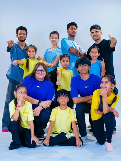 The whole crew together. This is our fam, a mix of instructors and students of all ages, striking a b-boy and b-girl pose after a great session in the studio. We welcome everyone to join our community.
