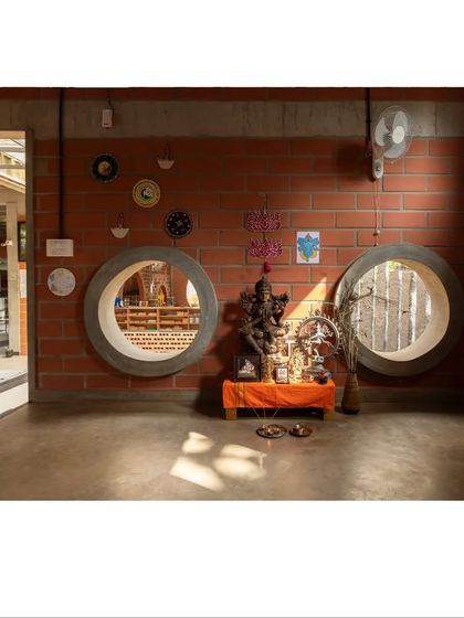 Playful circular windows, or 'hollow rings', offer visual connections between different spaces. They allow children to peek into other classrooms, fostering a sense of community and curiosity about what others are learning.