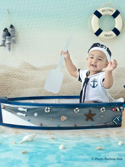 All aboard! A happy baby boy enjoys our nautical sailor theme, perfect for a sitter session. These milestone photoshoots capture your child's budding personality as they learn to sit up and explore.