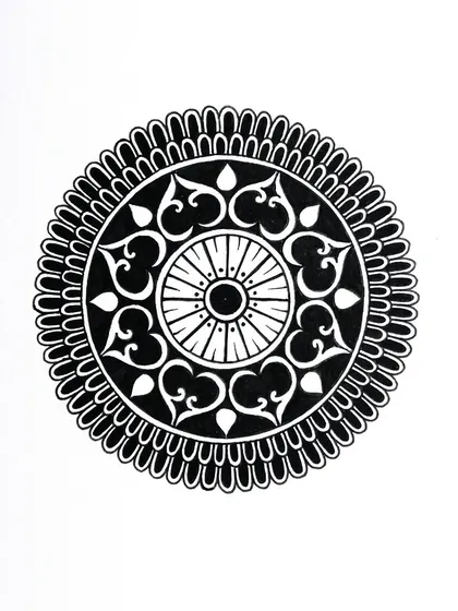 This was the last mandala I created for my Inktober 2022 challenge. It features heart-shaped motifs and a central wheel design, all done in black ink.