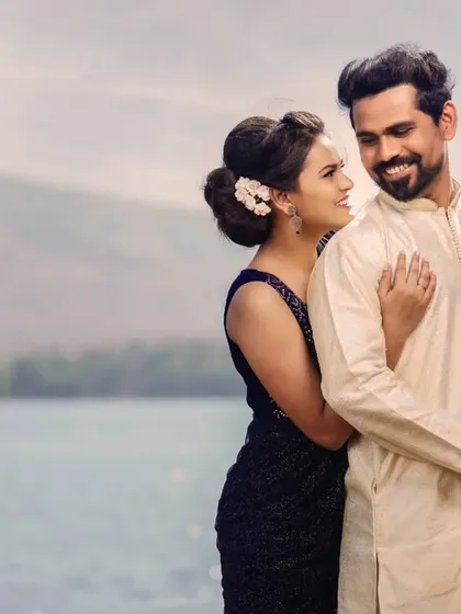 A beautiful portrait capturing a shared glance. The serene water and mountains in the background add a sense of calm and grandeur to this romantic pre-wedding photo.
