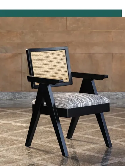 A frontal view of our Chandigarh Chair, showcasing its balanced proportions and the fine craftsmanship of its solid wood frame and cane back. It's a piece designed not just for looks, but for lasting comfort and durability.