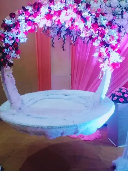 For a beautiful naming ceremony, we created this custom floral swing or 'jhula'. The design combines a dense arch of pink and white flowers with soft, elegant draping to create a magical focal point.