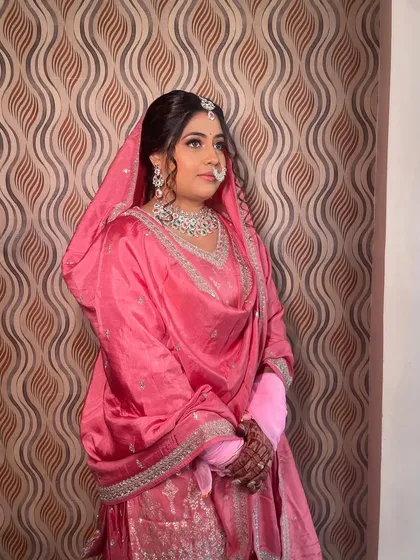 A portrait of the bride, showcasing her soft glam makeup and traditional jewelry.