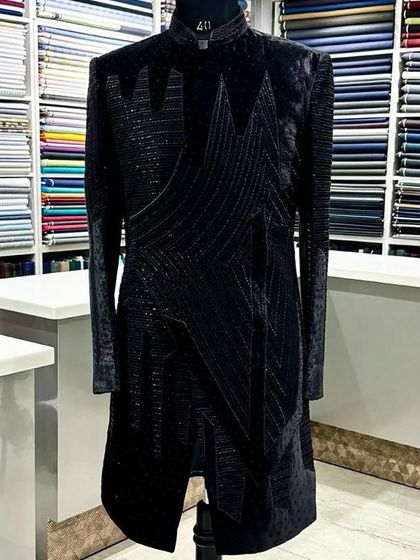 A side view of the modern all-black Indo-Western outfit, highlighting its unique silhouette and texture.